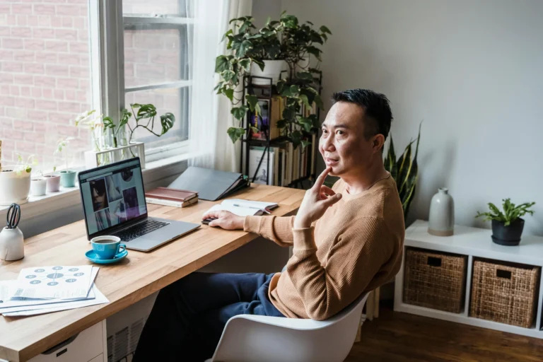 Asian man configuring a HRIS in a wfh setup Quadrant alpha