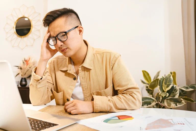 Asian man frustrated with wfh hr setup that is why HRIS philippines is solution quadrant alpha